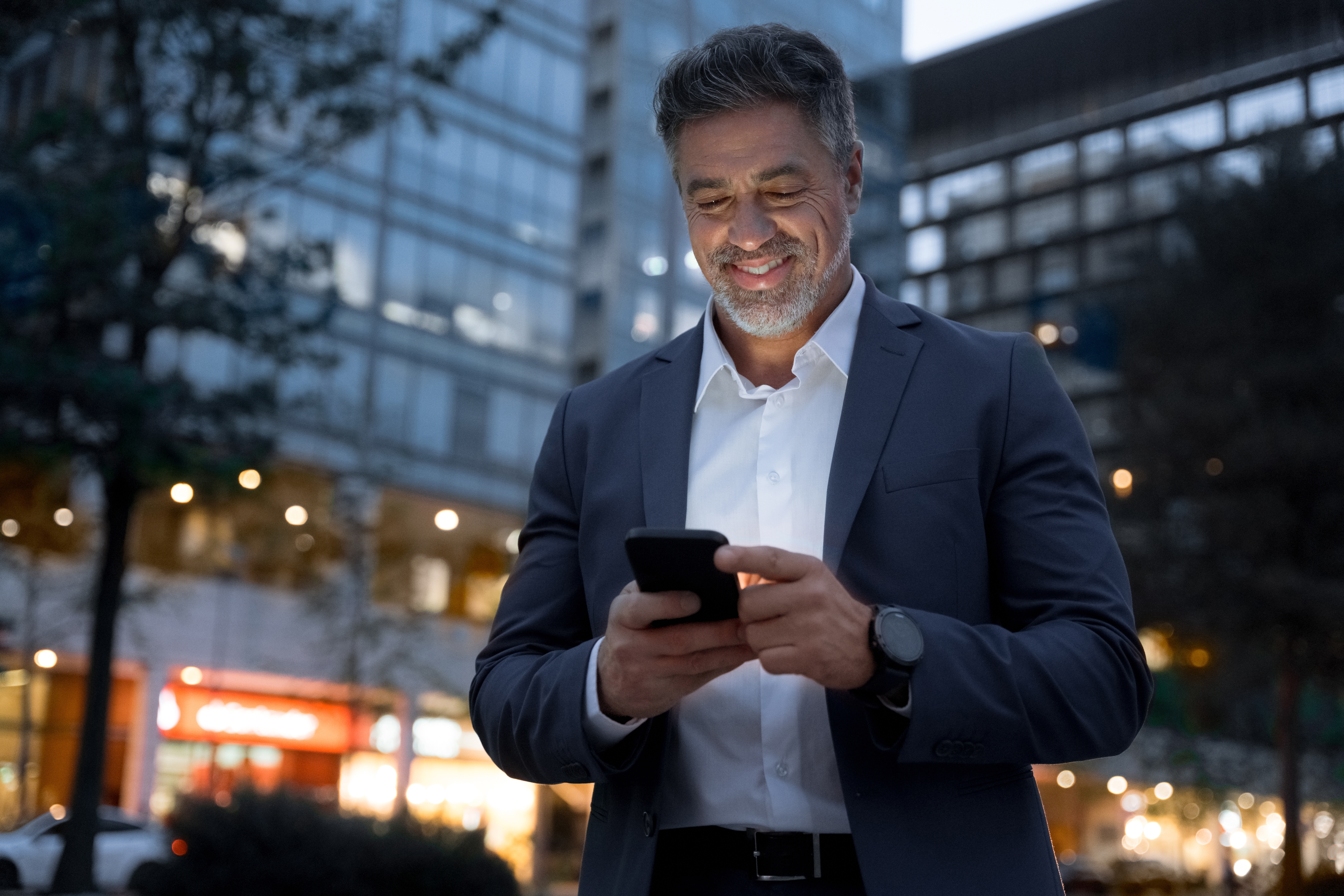 Man smiling at phone