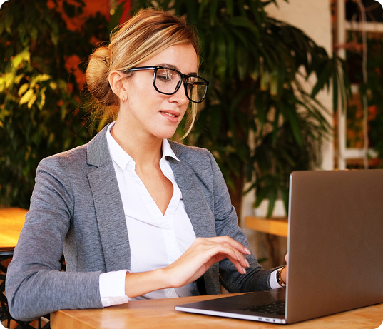 Businesswoman working on laptop representing ESOS Phase 4 Resource Hub